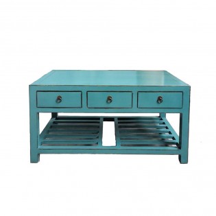 Low table with blue colored magazine rack